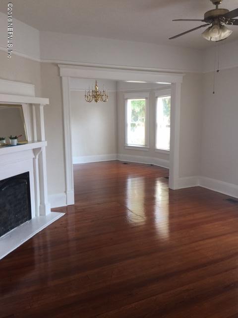 3308 St Augustine Road Jacksonville, FL 32207 - Photo 5 of 21 a view of empty room with wooden floor and fireplace
