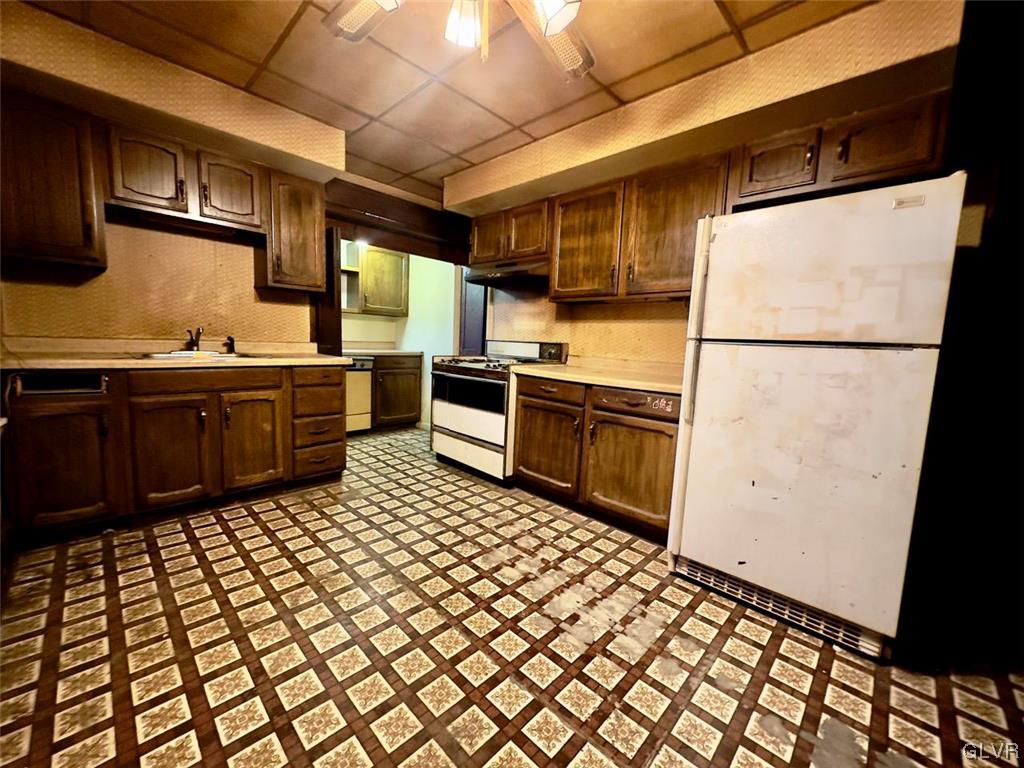 2052 West Broad Street Bethlehem, PA 18018 - Photo 7 of 23 a kitchen with stainless steel appliances a stove a sink and a refrigerator