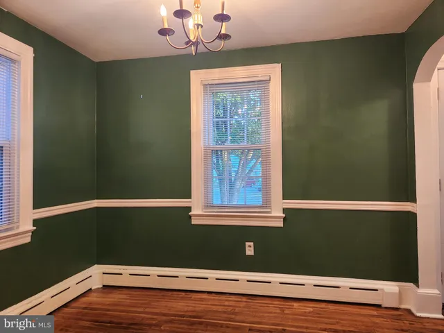 a view of a room with wooden floor and fan