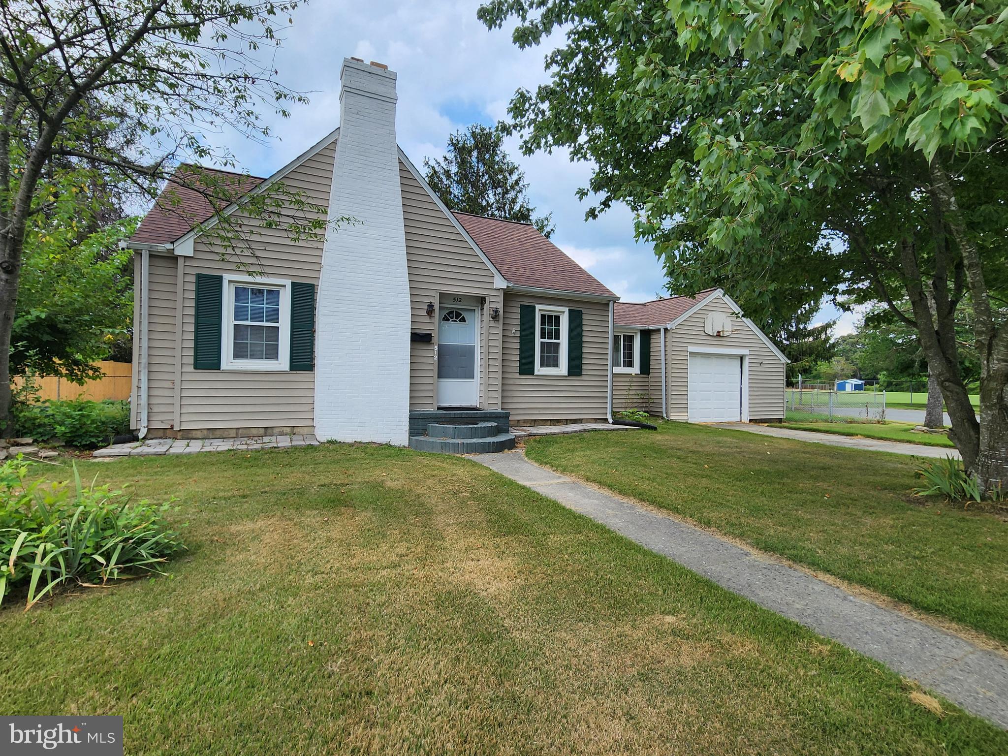 512 State Street Seaford, DE 19973 - Photo 2 of 32 a front view of a house with a garden