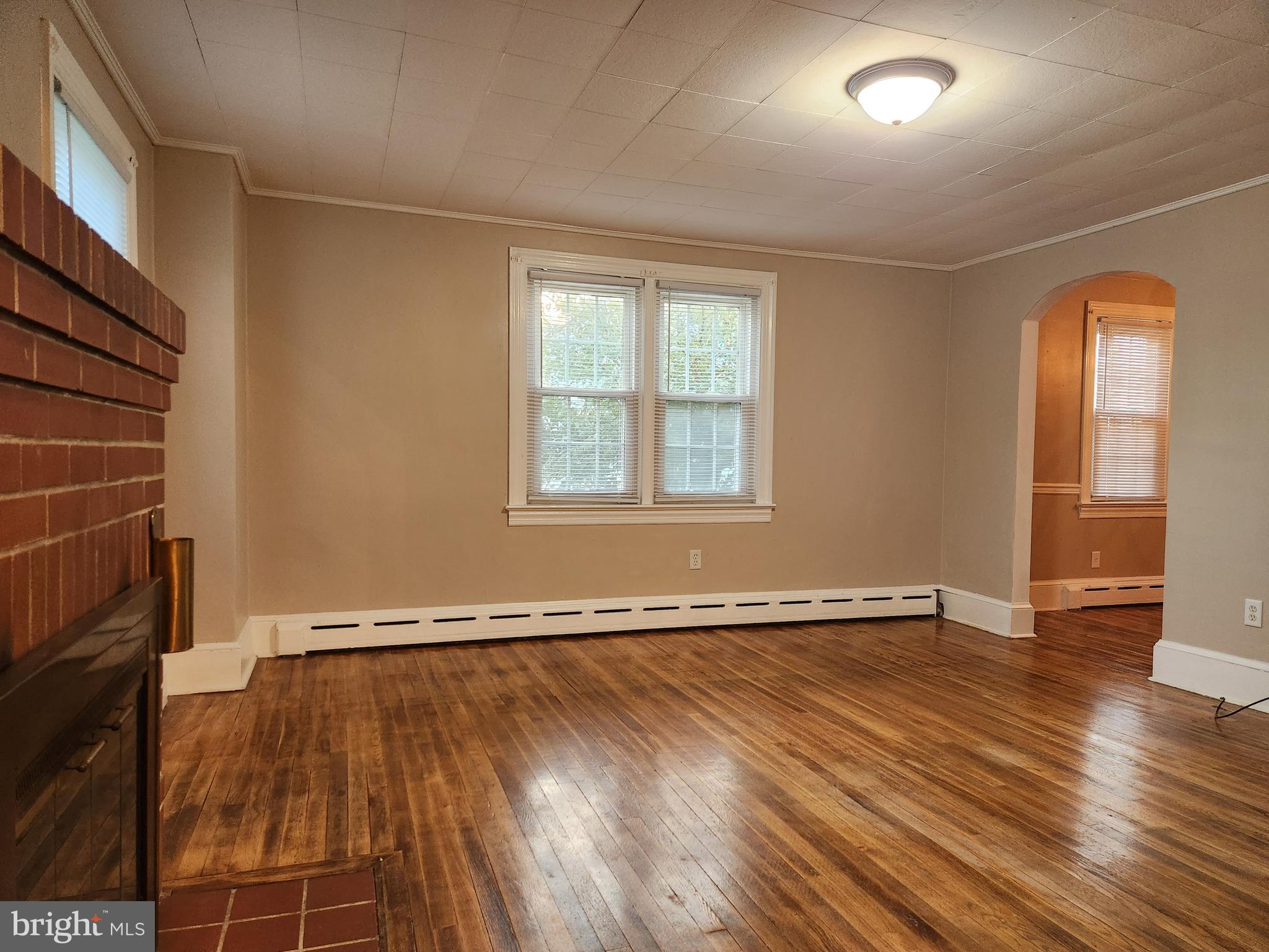512 State Street Seaford, DE 19973 - Photo 6 of 32 an empty room with wooden floor and windows