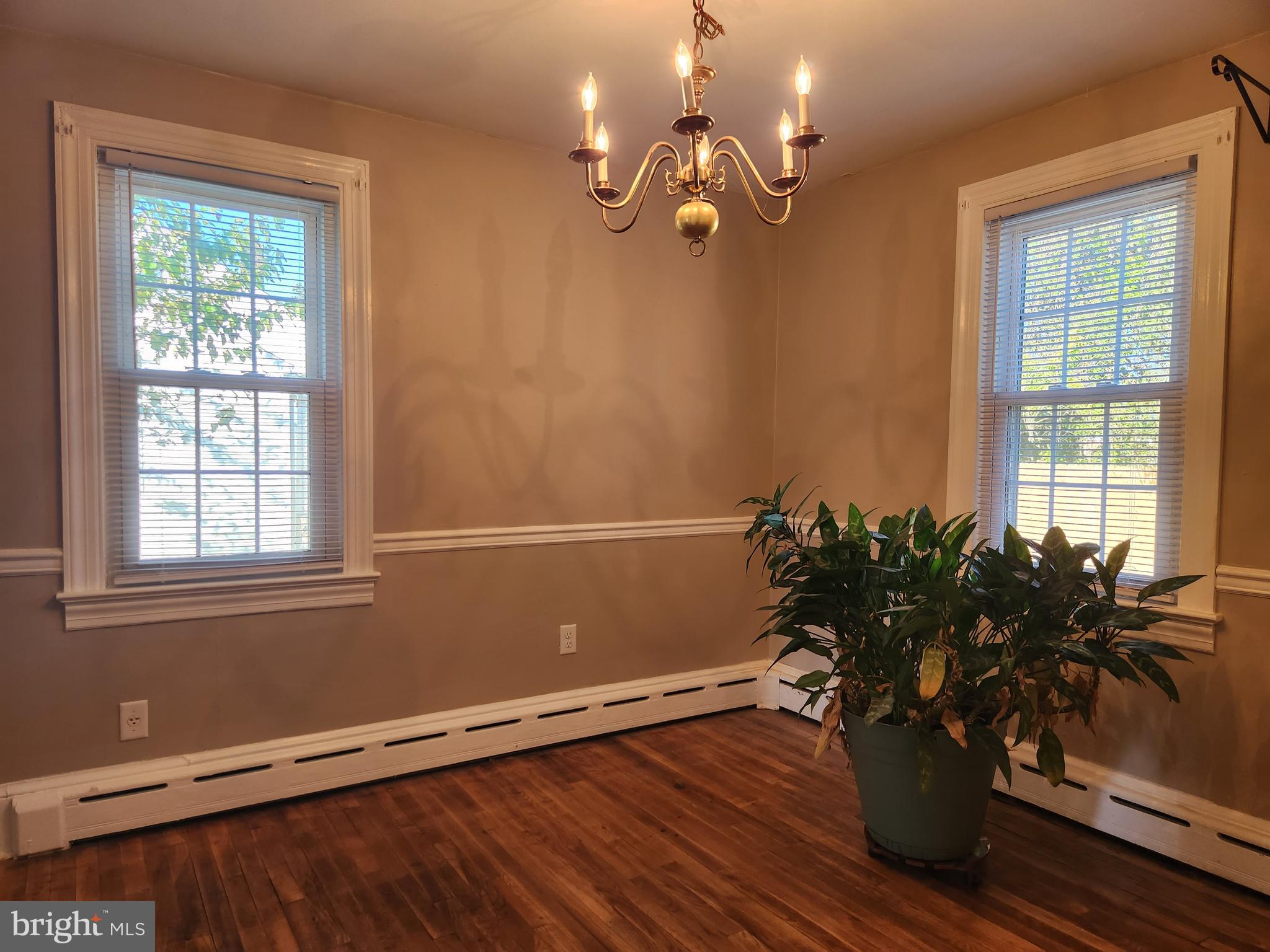 512 State Street Seaford, DE 19973 - Photo 7 of 32 a view of a room with wooden floor and potted plant