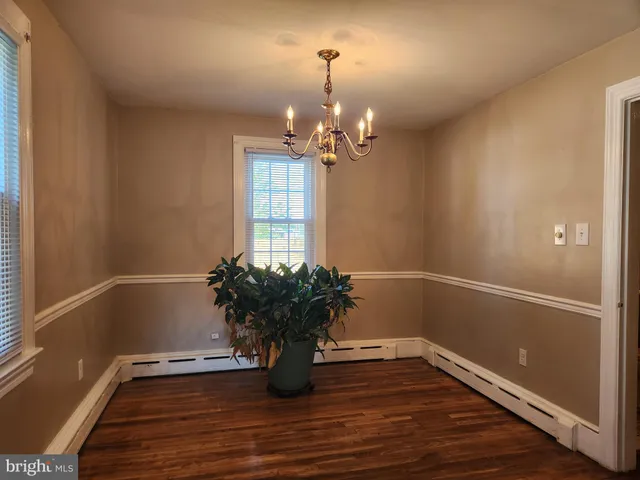 a view of a room with wooden floor and potted plant