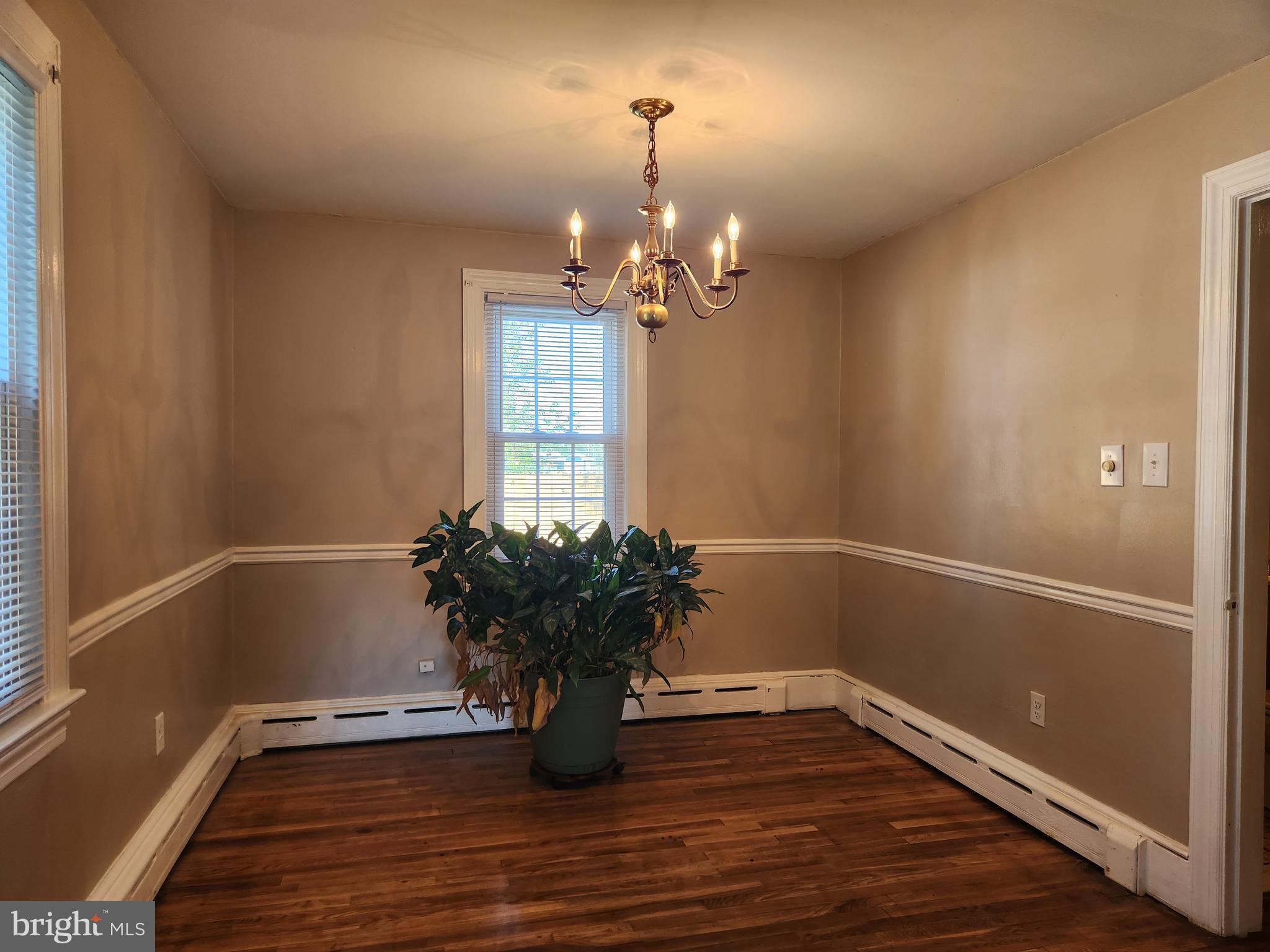512 State Street Seaford, DE 19973 - Photo 8 of 32 a view of a room with wooden floor and potted plant