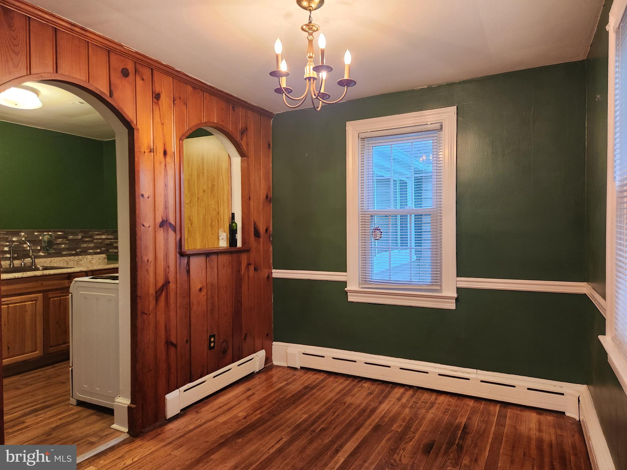 512 State Street Seaford, DE 19973 - Photo 9 of 32 a view of an empty room with wooden floor and a window