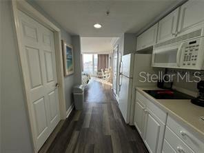 2700 North Atlantic Avenue, Unit 1003 Daytona Beach, FL 32118 - Photo 2 of 13 a kitchen with sink cabinets and stainless steel appliances