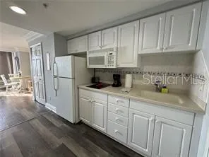 a kitchen with cabinets and a refrigerator