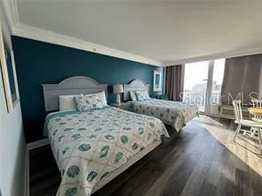 a bedroom with double bed and a large window