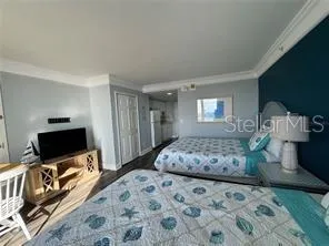 a bedroom with a bed and a flat screen tv