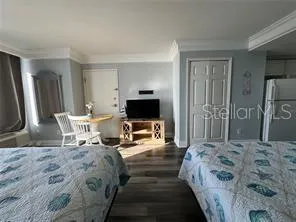 a bedroom with a bed and a flat screen tv