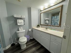 2700 North Atlantic Avenue, Unit 1003 Daytona Beach, FL 32118 - Photo 10 of 13 a bathroom with a toilet sink and mirror