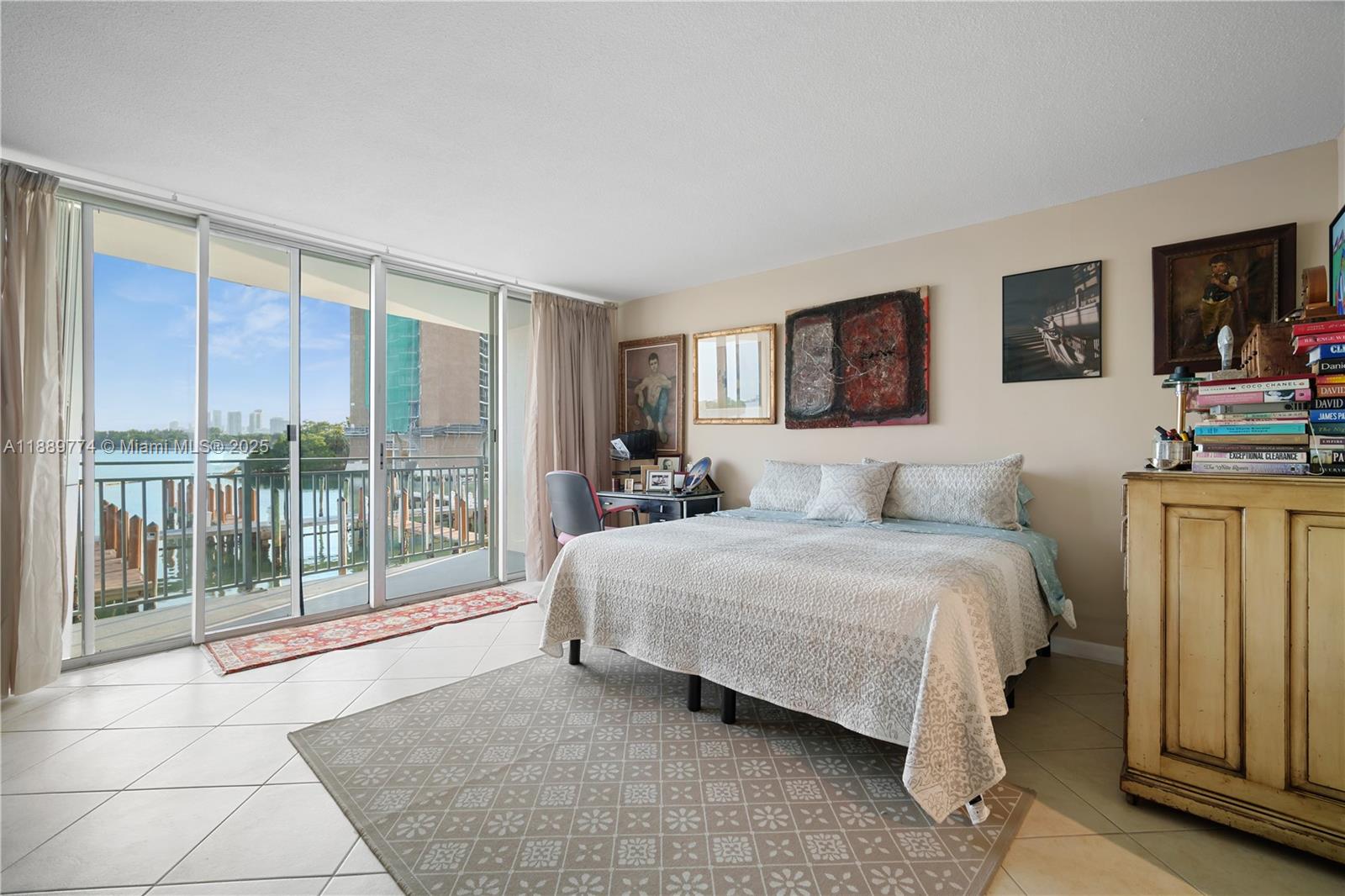 770 Northeast 69th Street, Unit 2H Miami, FL 33138 - Photo 13 of 39 a spacious bedroom with a bed and glass door