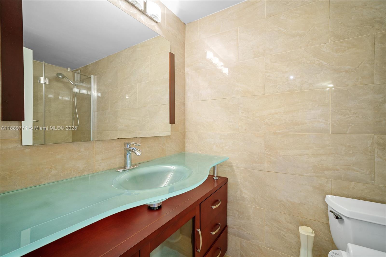 770 Northeast 69th Street, Unit 2H Miami, FL 33138 - Photo 16 of 39 a bathroom with a sink and a mirror