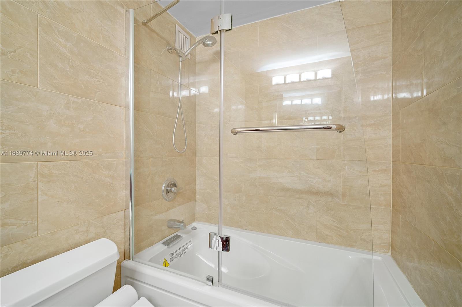770 Northeast 69th Street, Unit 2H Miami, FL 33138 - Photo 17 of 39 a bathroom with a bathtub and a shower