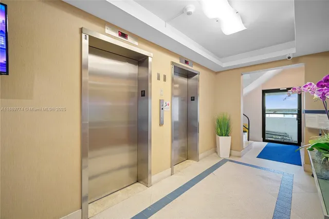 a spacious bathroom with a glass shower door and a glass door