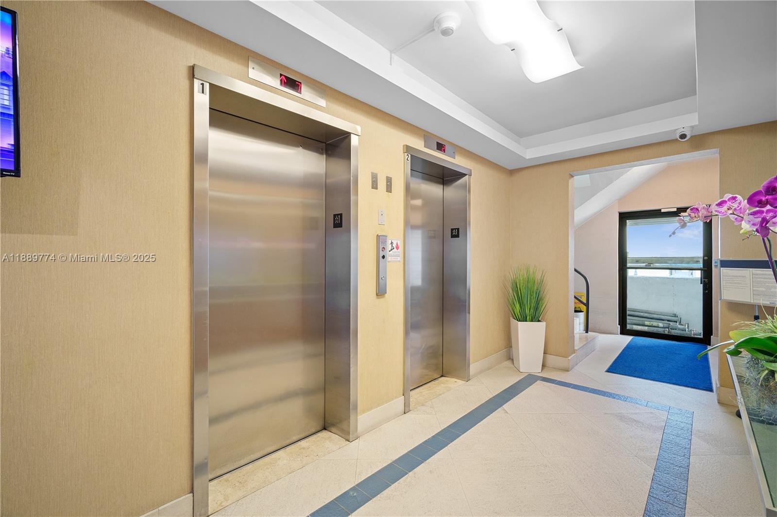 770 Northeast 69th Street, Unit 2H Miami, FL 33138 - Photo 5 of 39 a spacious bathroom with a glass shower door and a glass door