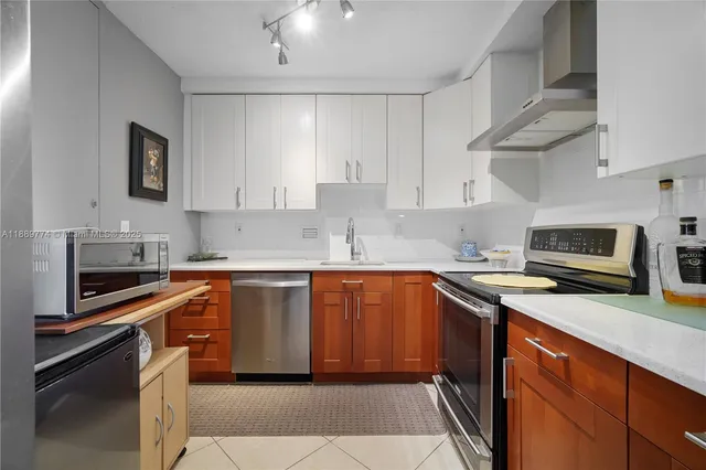 a kitchen with stainless steel appliances granite countertop a sink stove microwave and cabinets