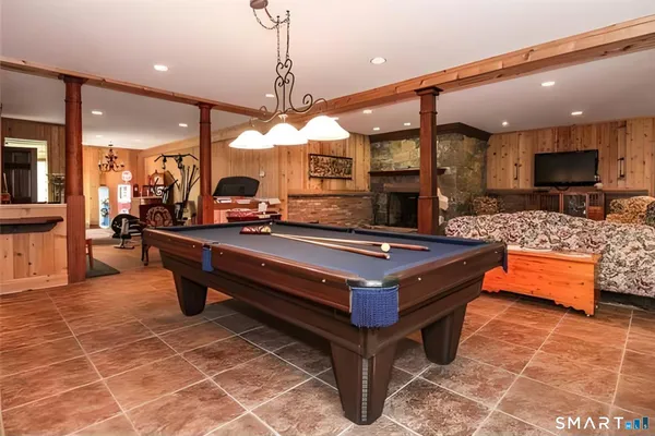 a living room with furniture a flat screen tv and kitchen view