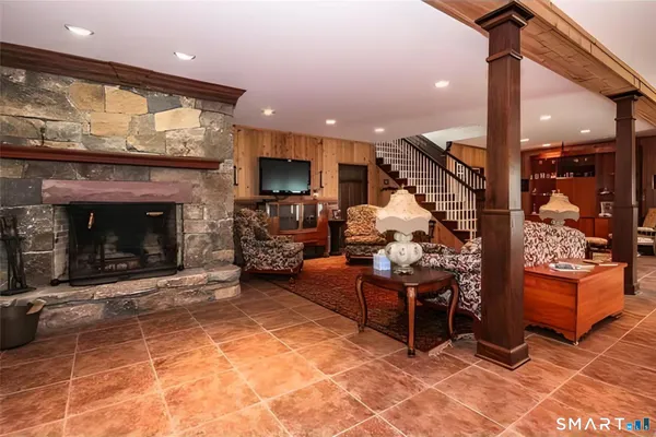 a living room with furniture a flat screen tv and a fireplace