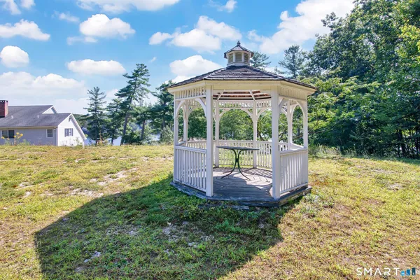 a view of a house with backyard and sitting area