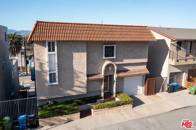 a front view of a house with garage