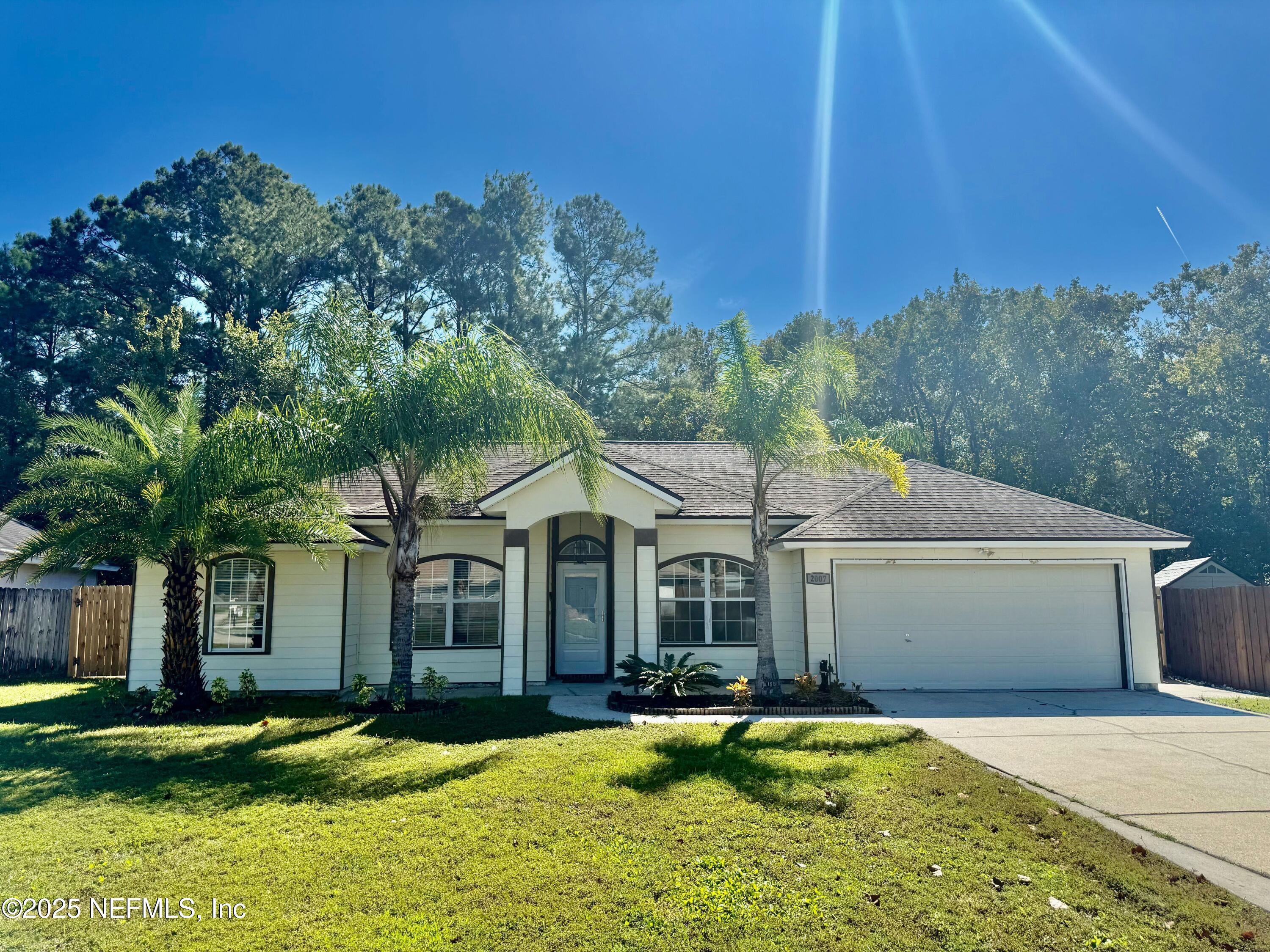 2007 Eclipse Drive Middleburg, FL 32068 - Photo 1 of 3 a front view of a house with a garden and yard