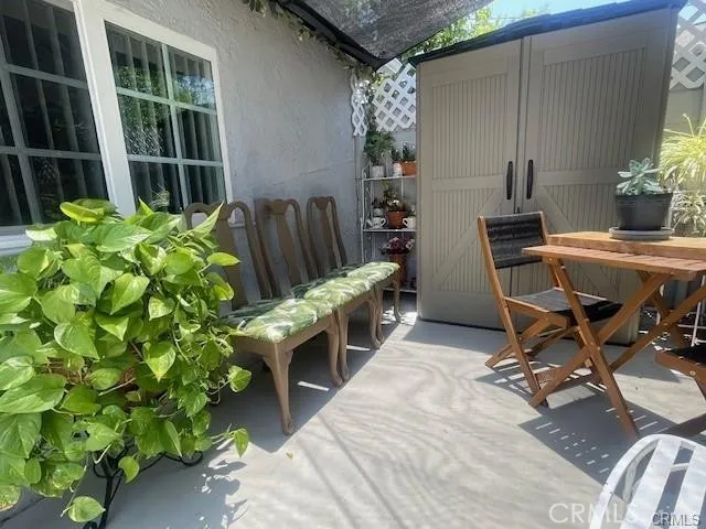 a balcony with table and chairs