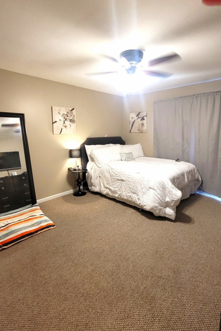 2295 Windsor Lane Country Club Hills, IL 60478 - Photo 7 of 12 a bedroom with a bed and a chandelier