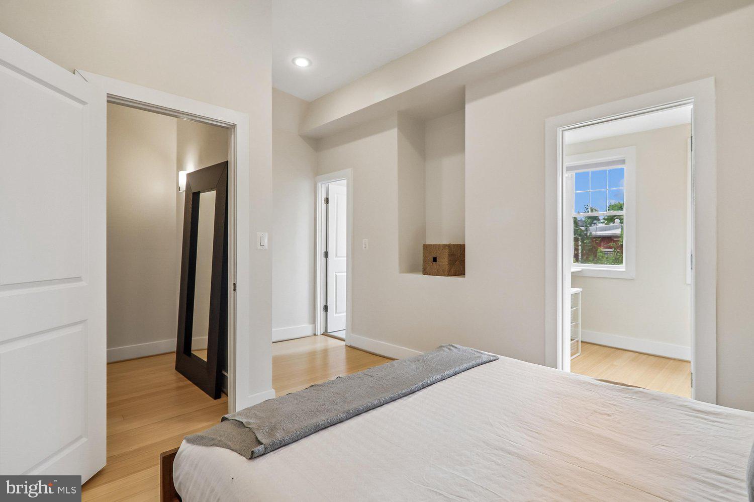 911 L Street Northeast Washington, DC 20002 - Photo 23 of 48 a bedroom with a bed and a mirror