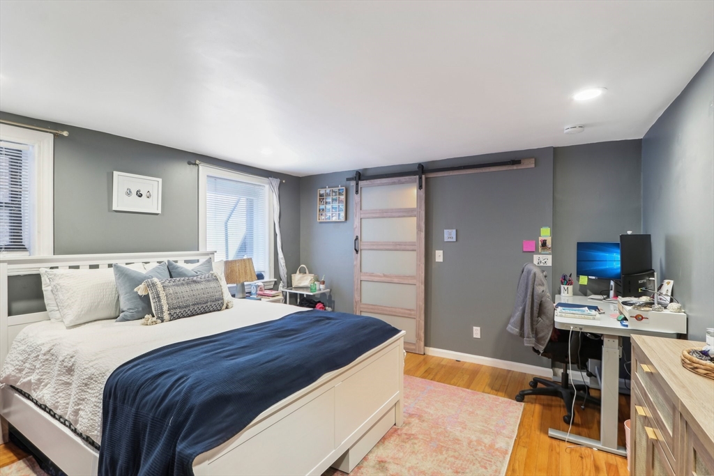 431 Shawmut Avenue, Unit 2 Boston, MA 02118 - Photo 14 of 25 a bedroom with a bed and a desk