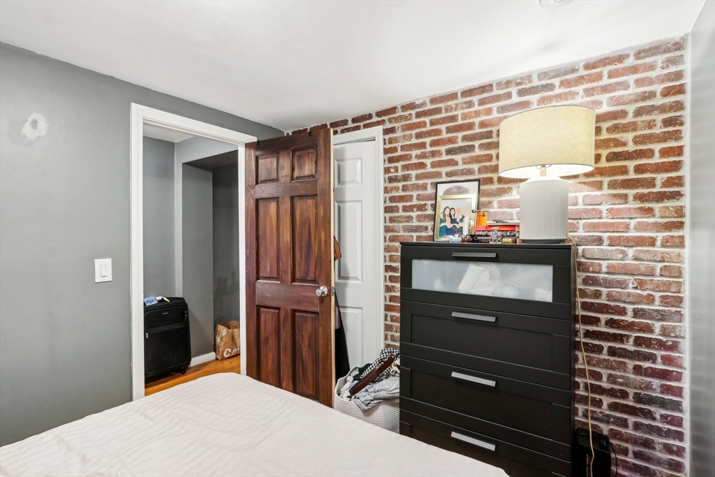 431 Shawmut Avenue, Unit 2 Boston, MA 02118 - Photo 21 of 25 a bedroom with a bed and a dresser