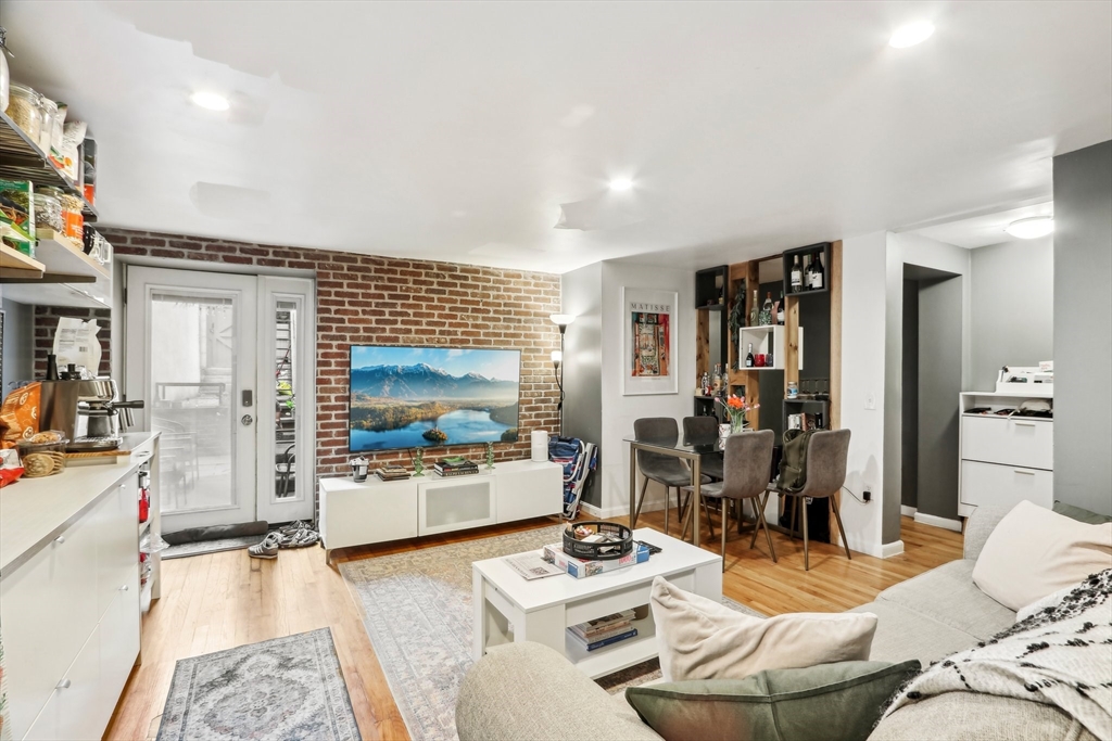 431 Shawmut Avenue, Unit 2 Boston, MA 02118 - Photo 6 of 25 a living room with furniture and a flat screen tv