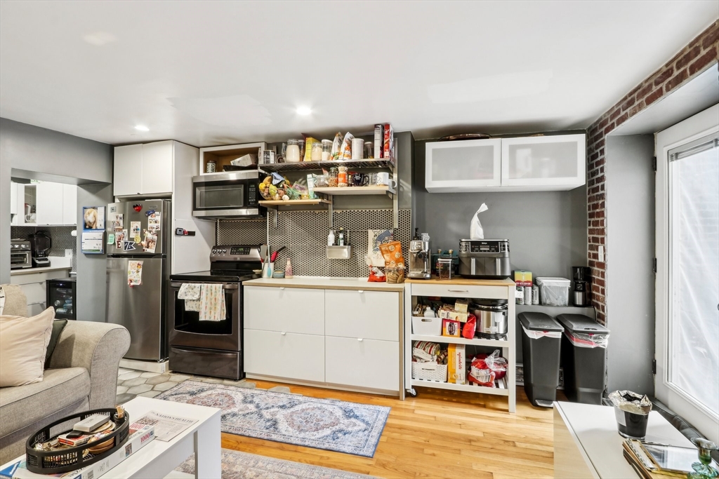 431 Shawmut Avenue, Unit 2 Boston, MA 02118 - Photo 7 of 25 a living room with stainless steel appliances kitchen island granite countertop a refrigerator and cabinets