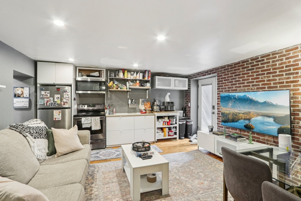 431 Shawmut Avenue, Unit 2 Boston, MA 02118 - Photo 8 of 25 a living room with furniture and a flat screen tv