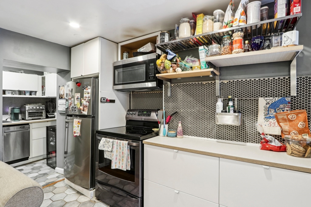 431 Shawmut Avenue, Unit 2 Boston, MA 02118 - Photo 10 of 25 a kitchen with stainless steel appliances kitchen island granite countertop a sink stove and refrigerator