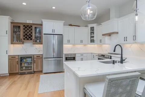 a kitchen with stainless steel appliances a refrigerator sink and cabinets