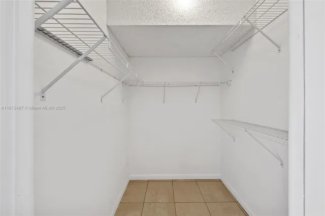 a view of an empty room and wooden floor