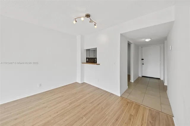 a view of a room with wooden floor