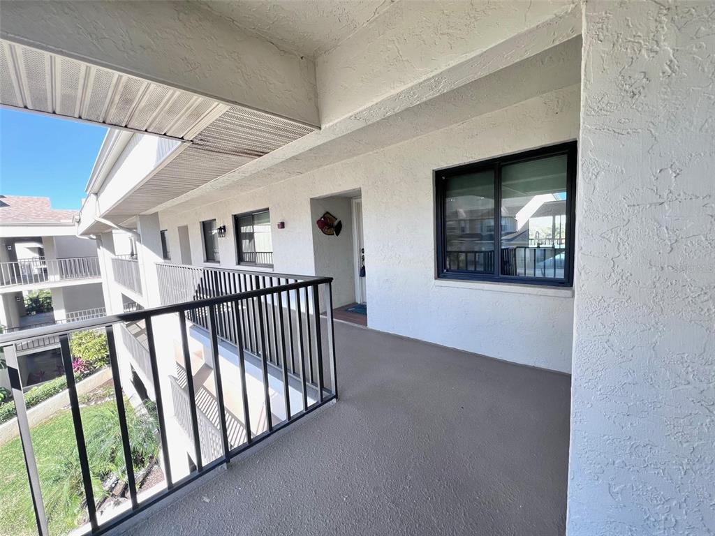 8210 Aquila Street, Unit 227 Port Richey, FL 34668 - Photo 11 of 68 a view of staircase with lots of frames on wall and a window