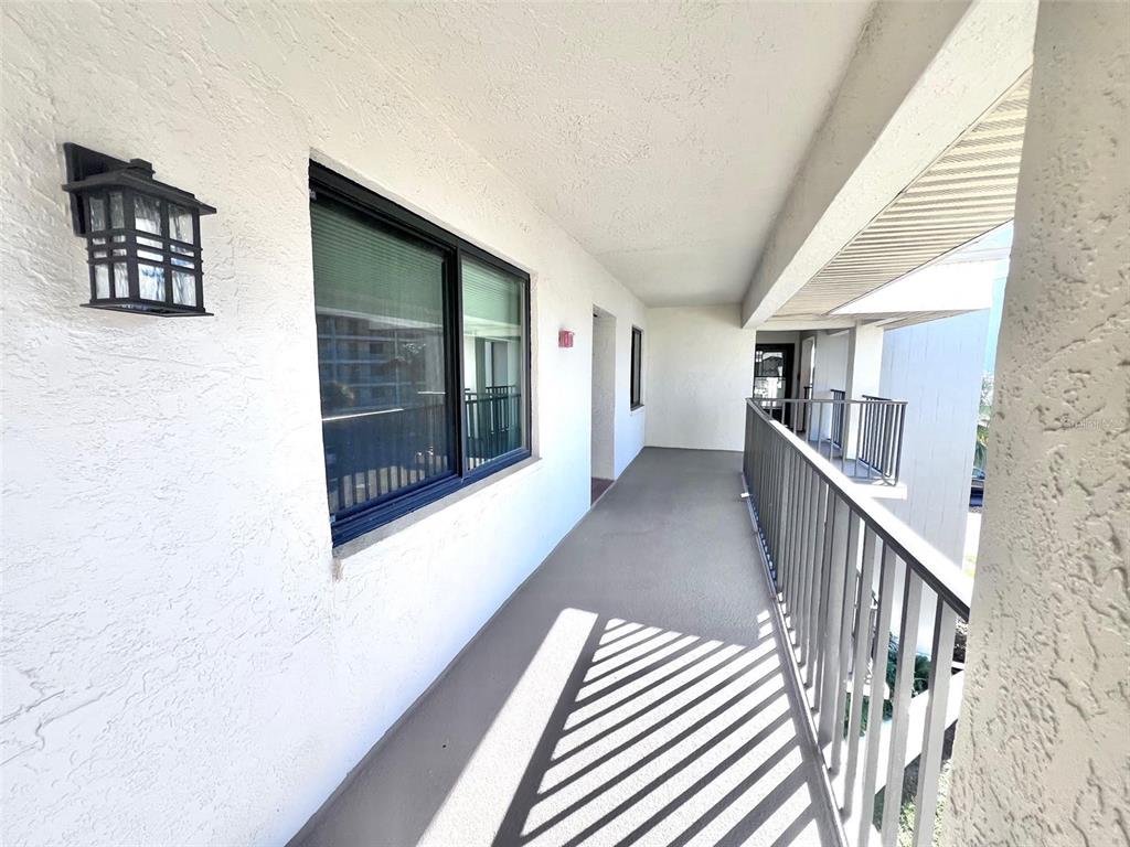 8210 Aquila Street, Unit 227 Port Richey, FL 34668 - Photo 12 of 68 a view of a hallway with wooden floor and windows