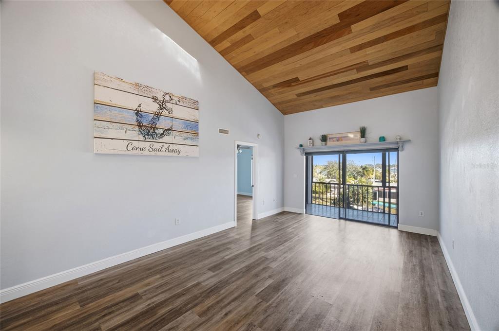 8210 Aquila Street, Unit 227 Port Richey, FL 34668 - Photo 24 of 68 an empty room with wooden floor and windows