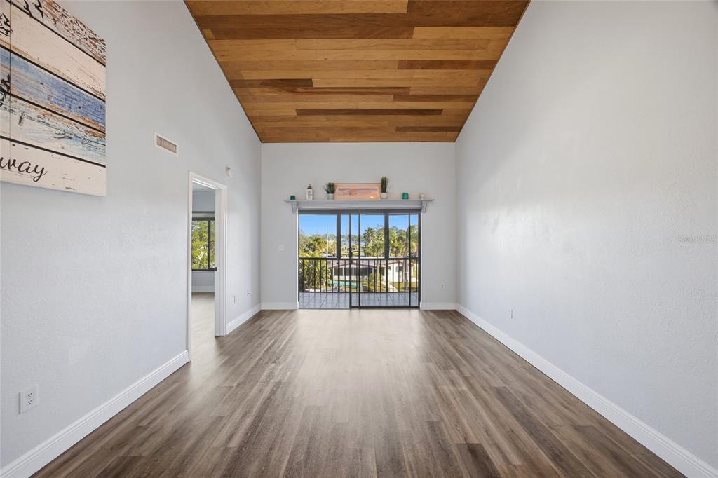 8210 Aquila Street, Unit 227 Port Richey, FL 34668 - Photo 27 of 68 a view of an empty room with wooden floor and a window