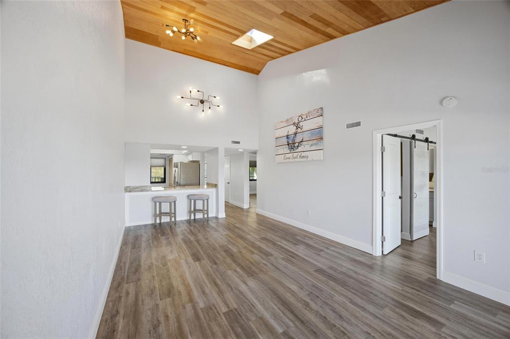 8210 Aquila Street, Unit 227 Port Richey, FL 34668 - Photo 28 of 68 a living room with furniture and a wooden floor