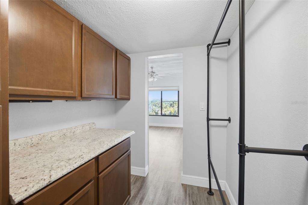 8210 Aquila Street, Unit 227 Port Richey, FL 34668 - Photo 31 of 68 a view of cabinets with wooden floor and window
