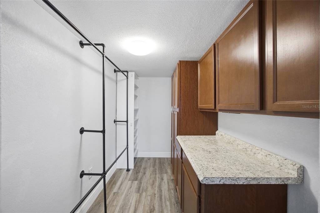 8210 Aquila Street, Unit 227 Port Richey, FL 34668 - Photo 32 of 68 a bathroom with a granite countertop sink and a mirror