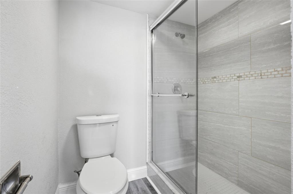 8210 Aquila Street, Unit 227 Port Richey, FL 34668 - Photo 35 of 68 a white toilet sitting next to a bathroom sink