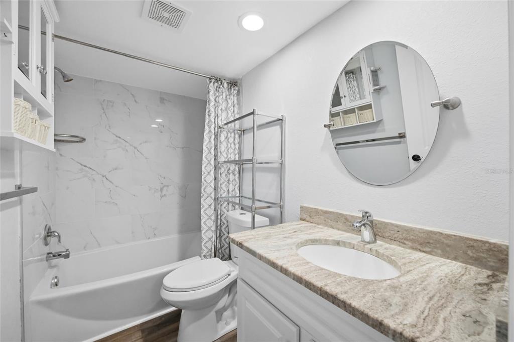 8210 Aquila Street, Unit 227 Port Richey, FL 34668 - Photo 41 of 68 a bathroom with a granite countertop sink toilet and shower