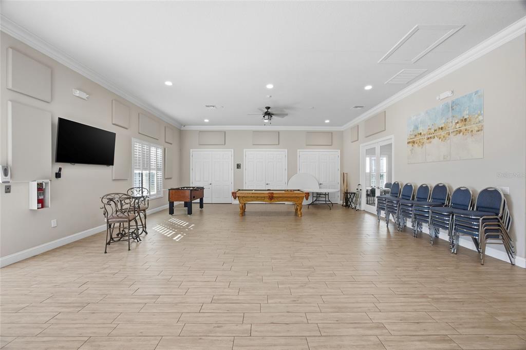 8210 Aquila Street, Unit 227 Port Richey, FL 34668 - Photo 54 of 68 a living room with furniture and a flat screen tv