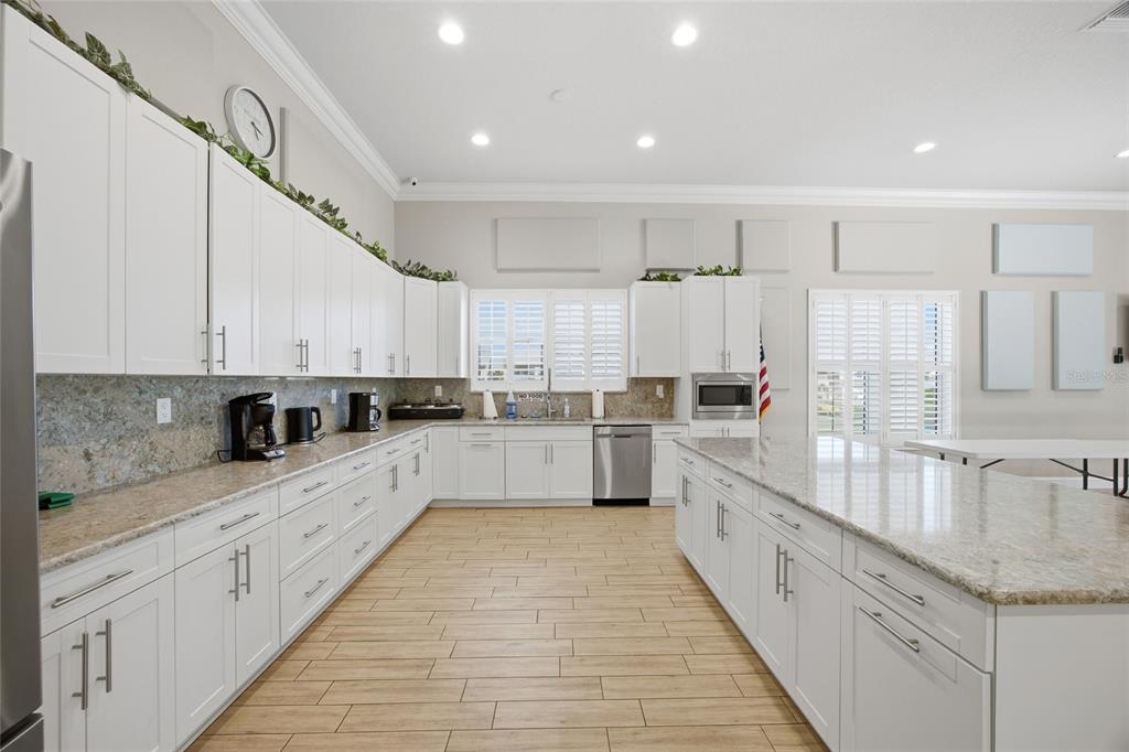 8210 Aquila Street, Unit 227 Port Richey, FL 34668 - Photo 55 of 68 a large kitchen with cabinets