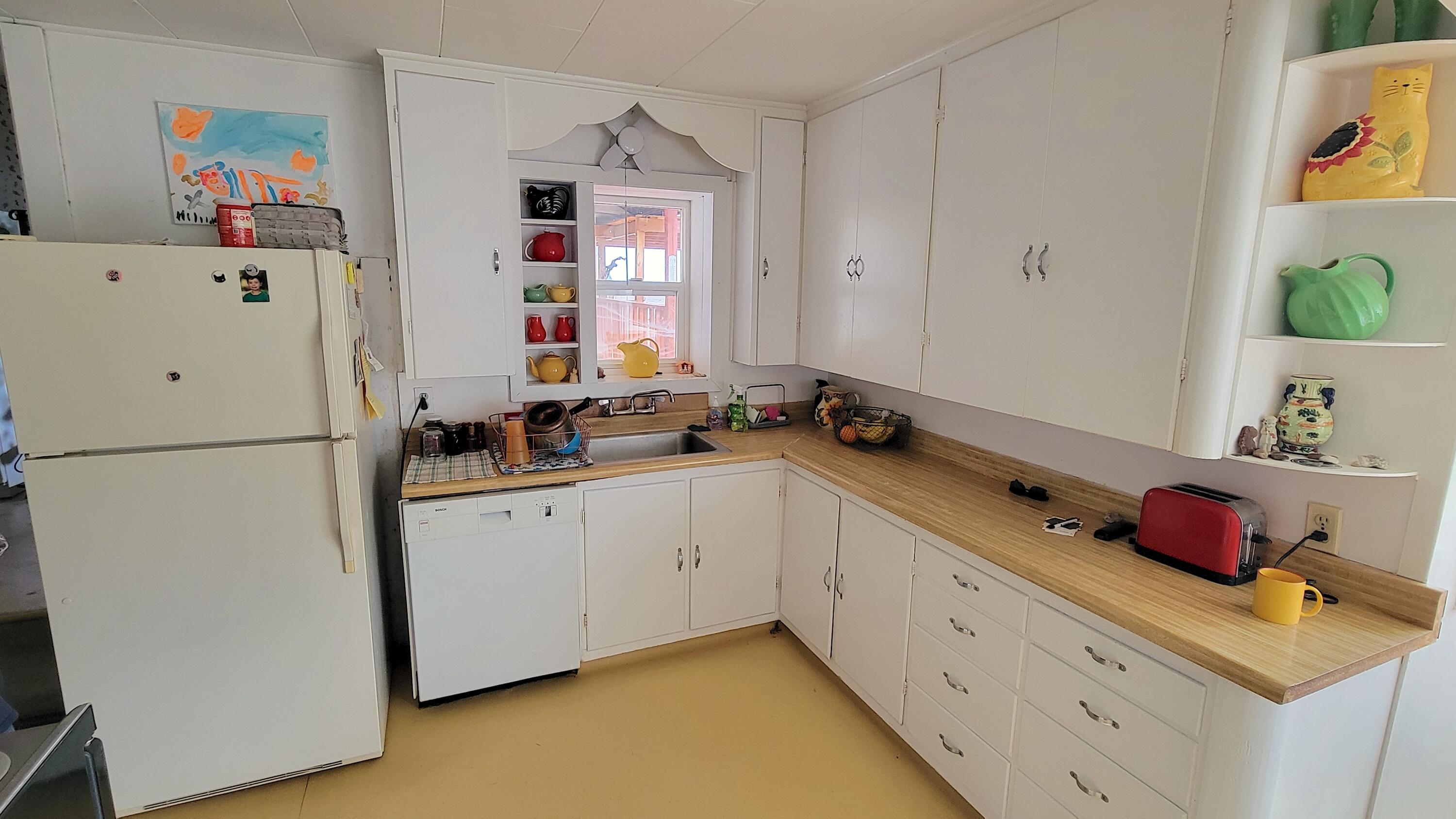 298 Main Street Monument, OR 97864 - Photo 14 of 66 a room with a refrigerator and a sink